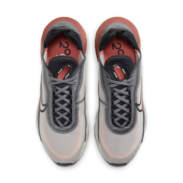 Nike Air Max 2090 sneakers featuring a mesh upper in gray with black laces, translucent overlays, and orange accents, top view.