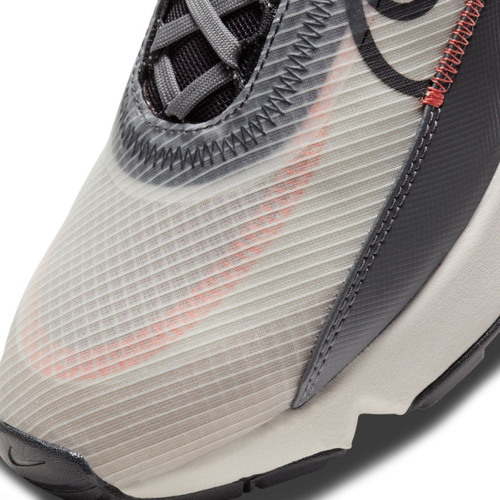 Nike Air Max 2090 running shoes with translucent mesh upper, visible orange accents, and textured gray overlays, close-up of toe box.