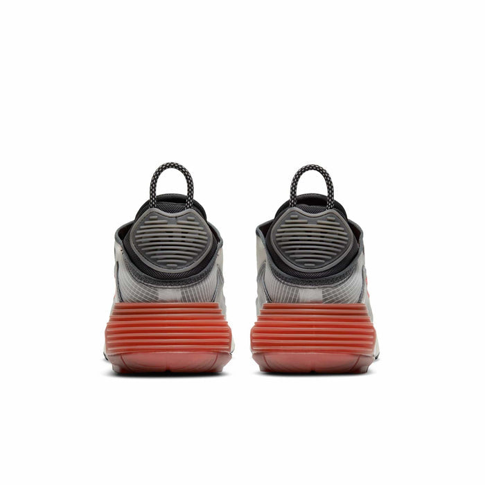 Nike Air Max 2090 sneakers back view featuring futuristic heel design, translucent upper, black pull tabs, and red rubber outsole.
