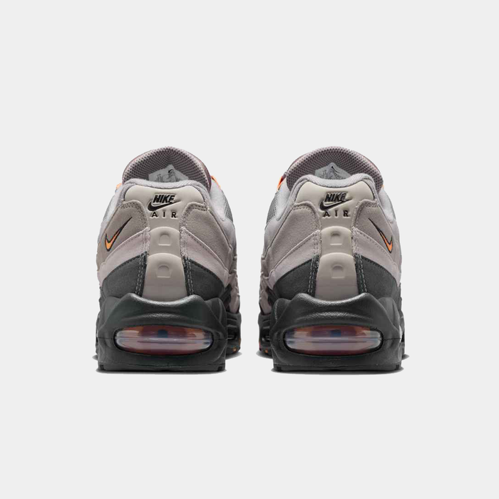 Nike Air Max 95 Big Bubble OG sneakers, back view in gray and black with visible air units and orange accents.