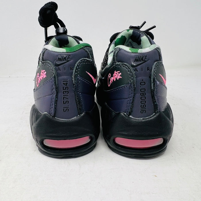 Introducing the Nike Air Max 95 SP Corteiz Pink Beam, black sneakers with textured design and purple accents. They feature a pink logo on the tongue, green and gray camo inner lining, black laces with toggle fasteners, fitting perfectly into 2021 fashion trends; available without a box.