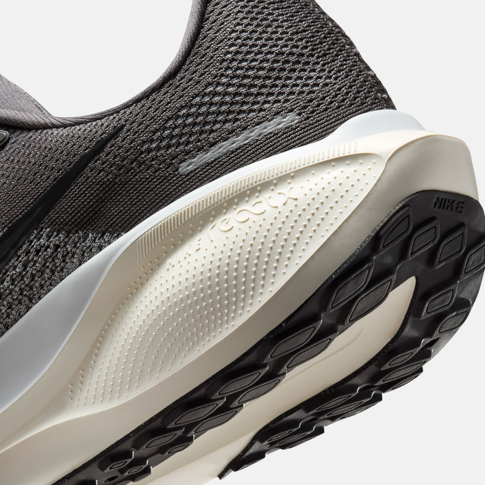 Close-up of a black and white athletic shoe with Nike branding.