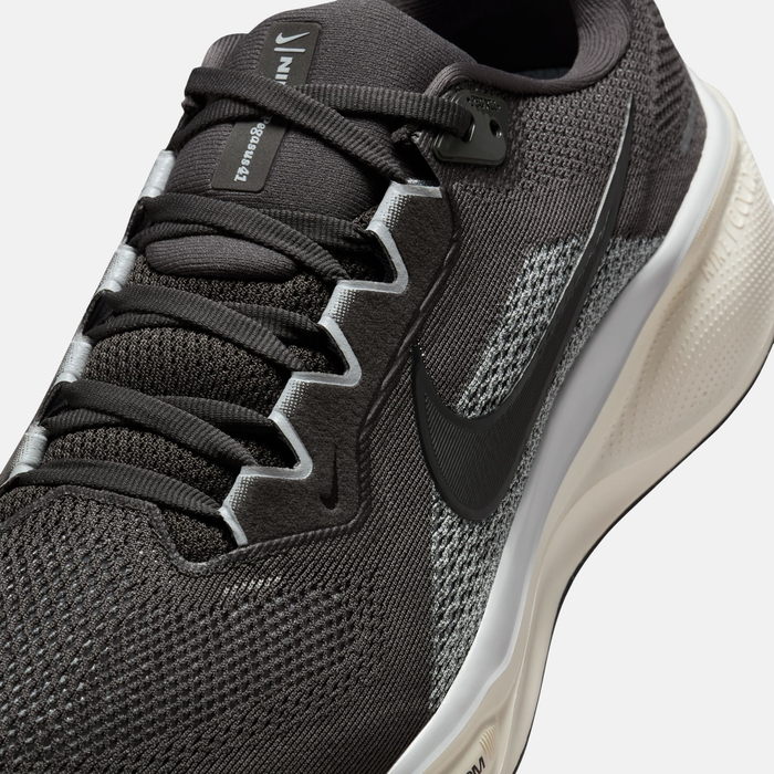 Gray running shoe with black laces and sole on a light gray background