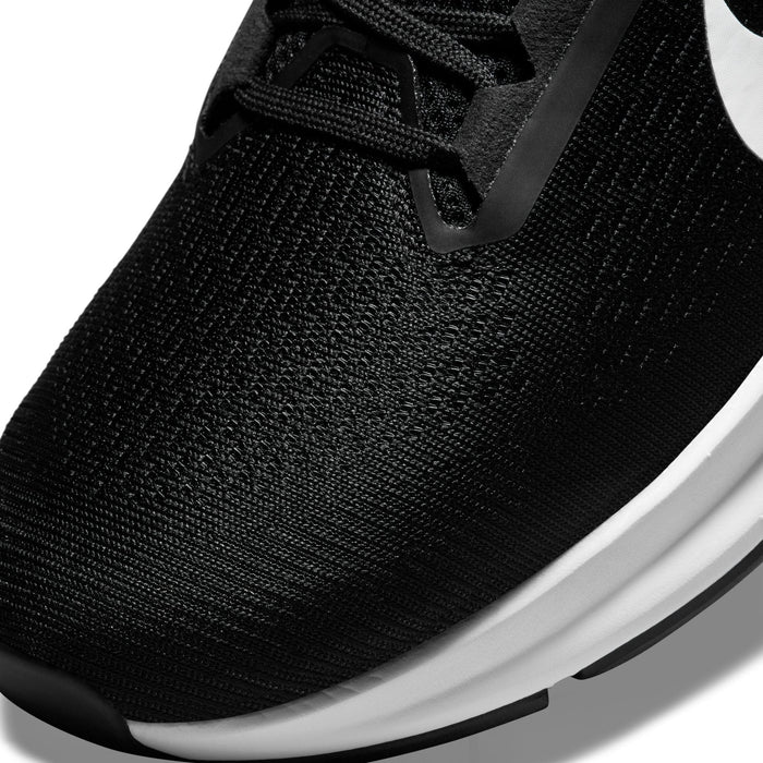 Nike Air Zoom Structure 24 running shoes close-up of the toe box, showcasing black breathable mesh upper with white midsole.