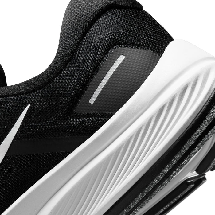 Nike Air Zoom Structure 24 running shoes, close-up of black mesh upper with reflective details and white midsole grooves.