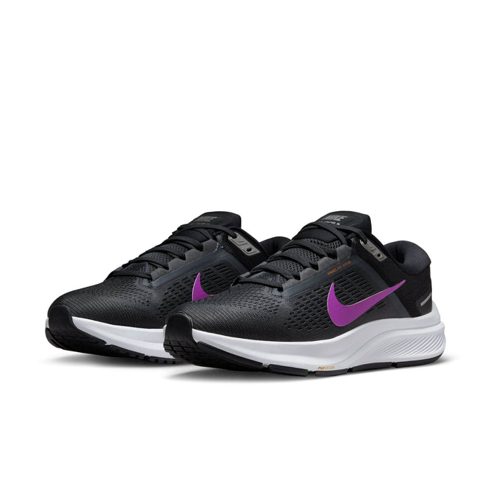 Nike Air Zoom Structure 24 running shoes in black with purple Swoosh, engineered mesh upper, and cushioned white midsole, angled front view.