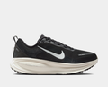 Nike Air Zoom Vomero 18 running shoes in black with white midsole and Nike Swoosh, side view showing ZoomX cushioning.