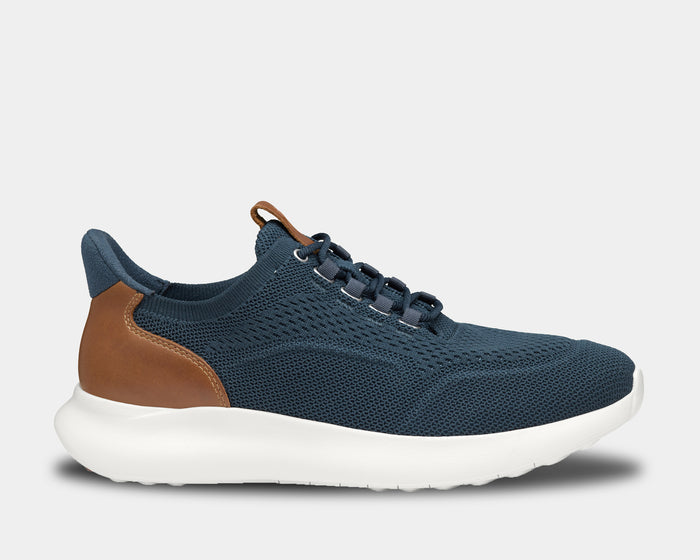 Johnston & Murphy Amherst 2.0 Knit Plain Toe shoes in navy blue knit material with tan leather heel accents and white sole, side view.