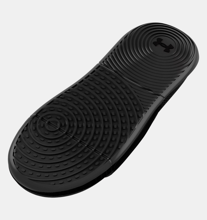 Under Armour Ansa Elevate sandal outsole in solid black, featuring textured circular grip patterns for traction and durability.