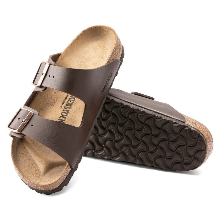 Birkenstock Arizona Birko-Flor® sandals in dark brown with adjustable buckles, cork footbed, and textured rubber outsole, angled view.