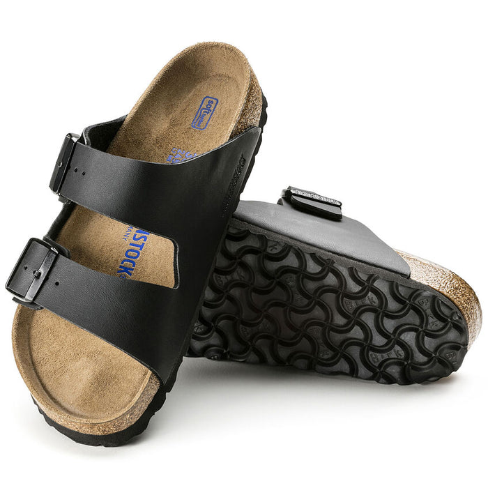 Birkenstock Arizona Soft Footbed Birko-Flor® sandals in black with adjustable straps, contoured cork footbed, and textured rubber outsole, angled view showing upper and sole.