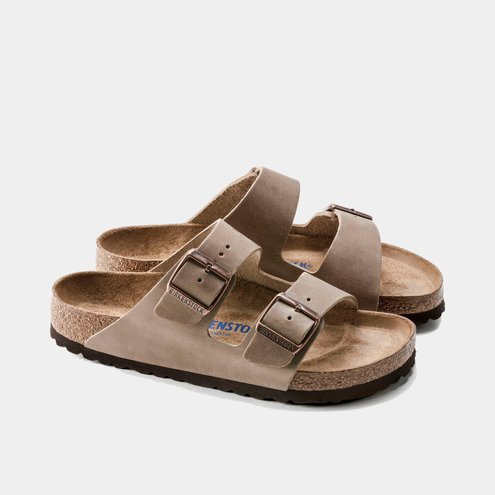 Birkenstock Arizona Soft Footbed Oiled Leather sandals in taupe with adjustable buckle straps and contoured cork-latex footbed, side angle.