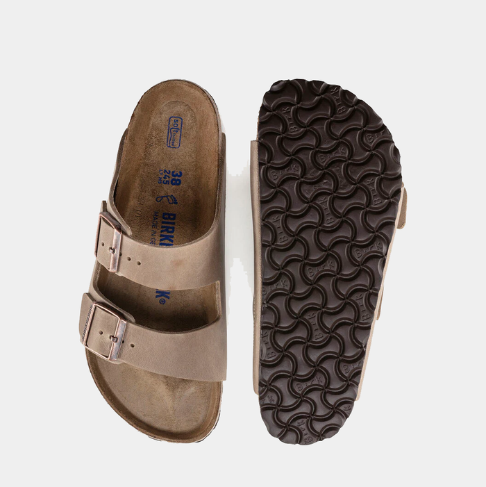 Birkenstock Arizona Soft Footbed Oiled Leather sandals in taupe with dual adjustable straps and contoured footbed, top and sole views.