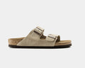 Birkenstock Arizona Suede sandals in taupe suede with dual adjustable straps and cork footbed, side view.