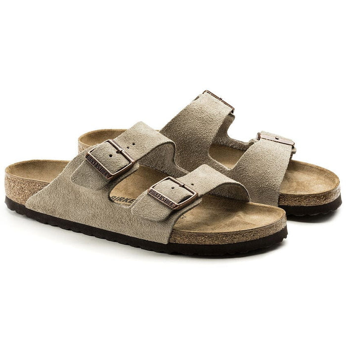 Birkenstock Arizona Suede sandals in taupe with adjustable buckle straps and cork-latex footbed, front side view.