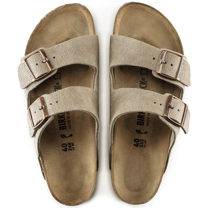 Birkenstock Arizona Suede sandals in beige with dual adjustable straps, copper buckles, and contoured cork footbed, top view.
