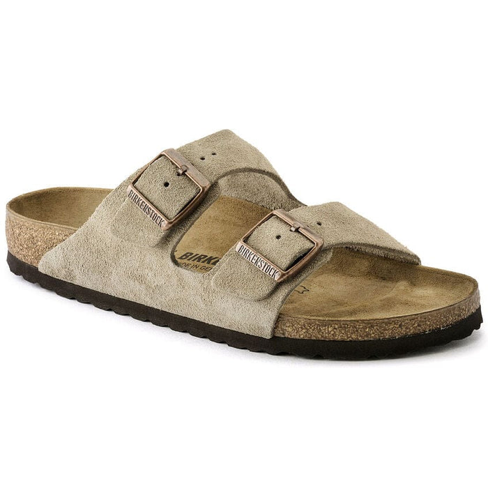 Birkenstock Arizona Suede sandals in taupe with dual adjustable straps, suede upper, contoured cork footbed, and black outsole, side view.