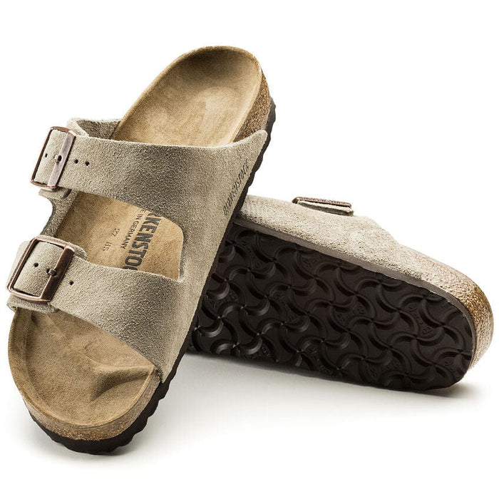 Birkenstock Arizona Suede sandals in taupe with adjustable straps, suede material, and cork footbed, side and sole view.