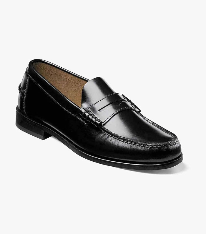Florsheim Berkley Penny Loafer shoes in polished black leather with moc toe stitching and penny strap detail, angled side view.