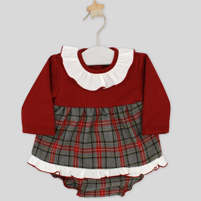 Red and plaid baby dress with white collar on a hanger against a light gray background