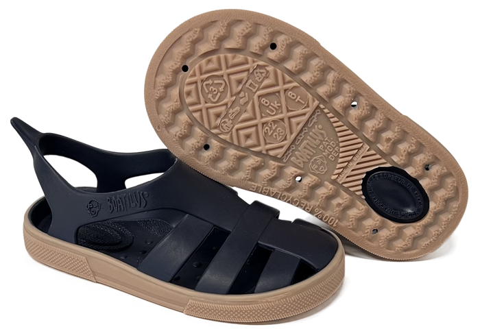 Black sandal with tan sole on a white background