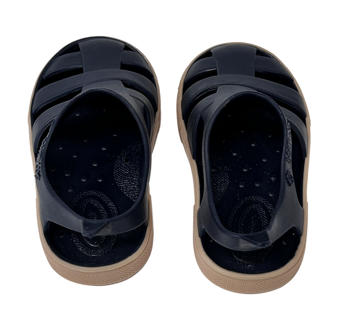Pair of black sandals with beige soles on a white background