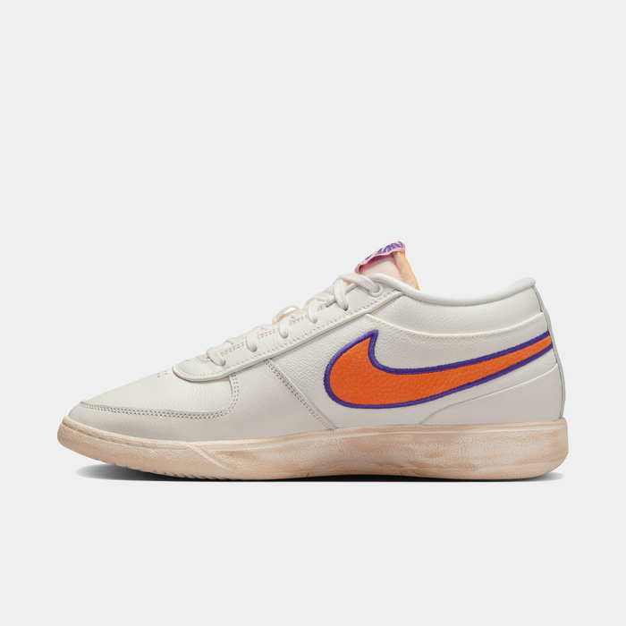 Nike Book 1 Decade sneakers in off-white leather with orange and purple swoosh, textured midsole, side view