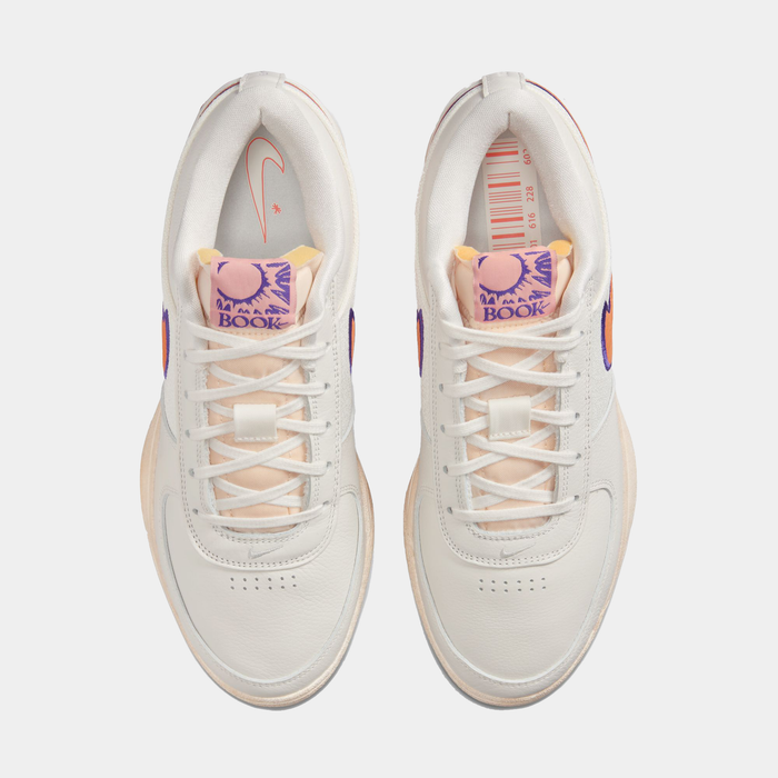 Nike Book 1 Decade sneakers in off-white with peach accents, purple branding on tongue, and perforated toe box, top view.