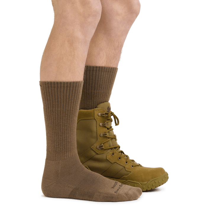 Darn Tough Boot Midweight Tactical Sock with Cushion in brown, ribbed design, and reinforced footbed, shown on a person wearing tactical boots.