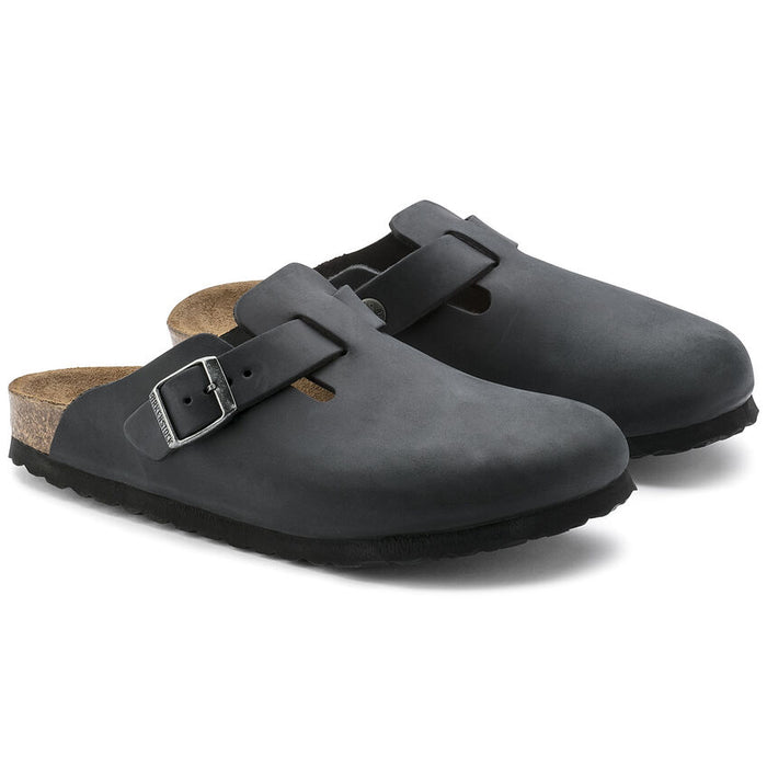 Birkenstock Boston Oiled Leather clogs in black with adjustable strap and buckle, cork footbed, and textured sole, angled front view.
