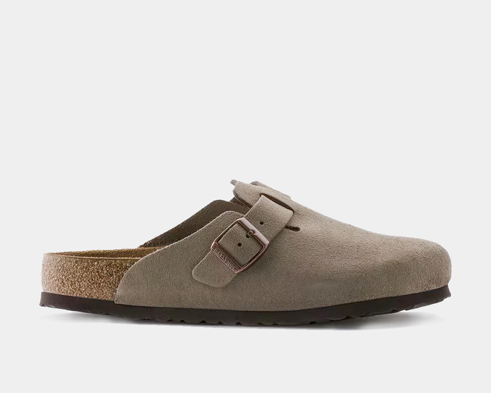 Birkenstock Boston Soft Footbed clogs in taupe suede with adjustable buckle strap and contoured sole, side view.