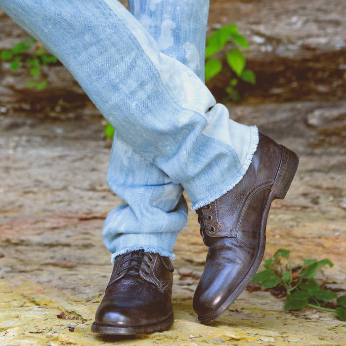 Bed Stu Bradley shoes in dark brown leather with a distressed finish, featuring lace-up closure, outdoor lifestyle setting.