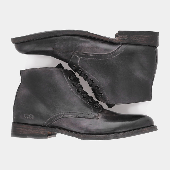 Bed Stu Bradley boots in distressed black leather with lace-up design and stacked wooden heel, side view.