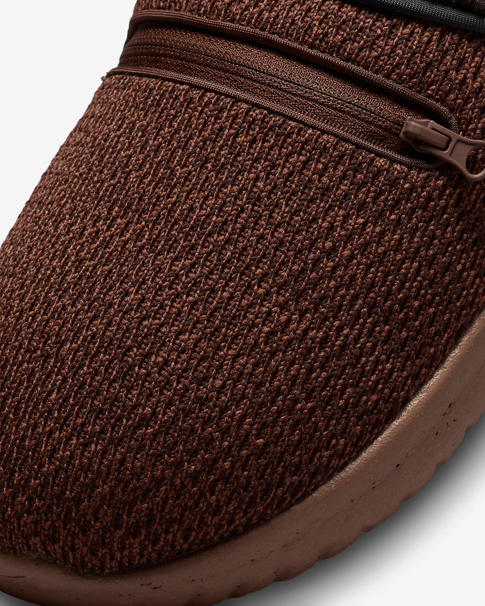Nike Burrow SE slipper with textured brown knit upper, zippered pocket detail, and cushioned brown sole, close-up of toe box.