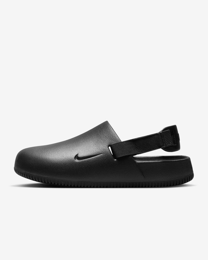 Nike Calm Mule slip-on shoes in black with adjustable heel strap and textured outsole, side view.