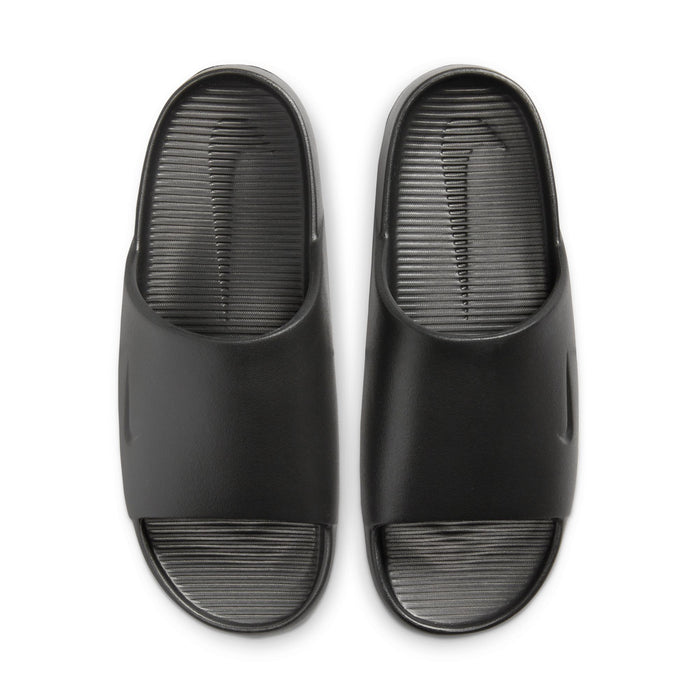 Nike Calm Slide sandals in black with sleek minimalist design and textured footbed, top view.