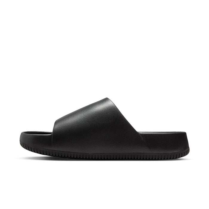 Nike Calm Slide sandals in black with a sleek synthetic upper and textured outsole, side view.