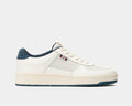 SeaVees Cardinal Sneaker in off-white with perforated leather panels, navy suede heel detail, and minimalist design, side view.