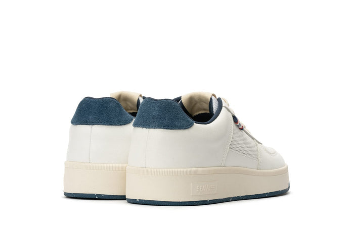 SeaVees Cardinal Sneaker in white with blue suede heel accent and textured cream sole, back view.