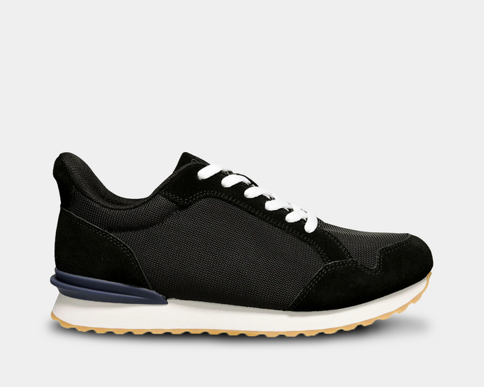 Propét Carmine Step In Sneakers in black with a breathable mesh upper, suede overlays, white laces, and a lightweight outsole, side view.