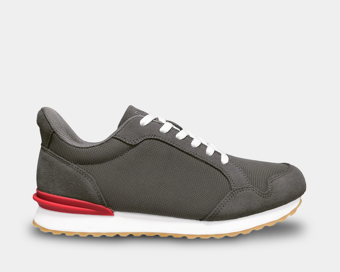 Propét Carmine Step In Sneakers, gray mesh sneakers with suede overlays, red heel accent, white sole, and gum outsole, side view.
