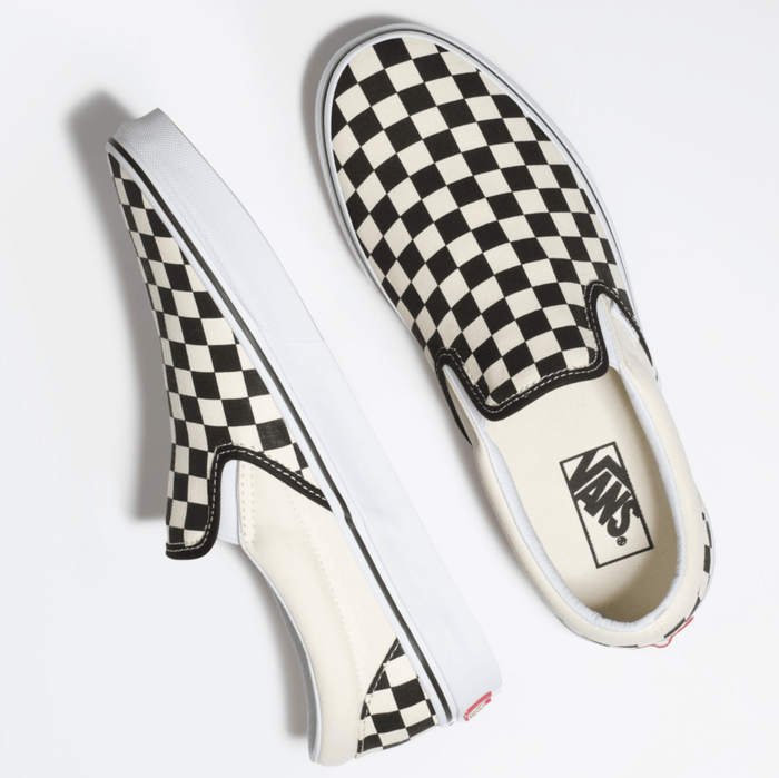 Vans Checkerboard Slip On shoes with black and white checkered canvas upper and white rubber sole, top view.
