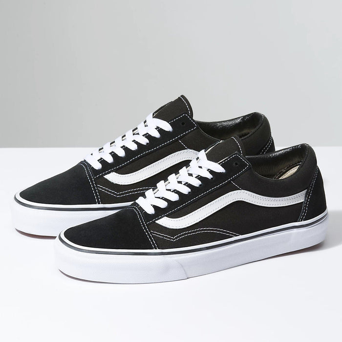 Vans Classic Old Skool sneakers in black with white suede and canvas upper, white side stripe, and vulcanized sole, side angle view.