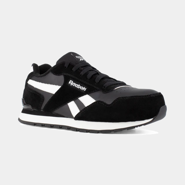 Reebok Work Classic Work Sneaker in black and white with suede and leather upper, perforated toe box, and durable outsole, angled side view.