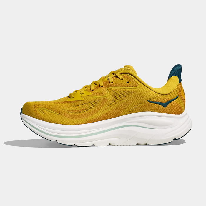 HOKA Clifton 10 running shoes in golden yellow with breathable mesh upper, cushioned white midsole, and teal heel detail, side view.