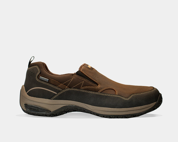 Dunham Cloud Plus Waterproof Slip-On shoes in brown with leather upper, elastic gore panels, and durable rubber outsole, side view.