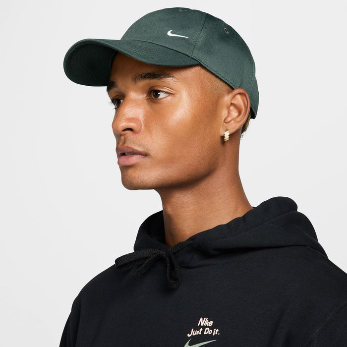 Nike Club Hat in dark green with embroidered white logo, front view.