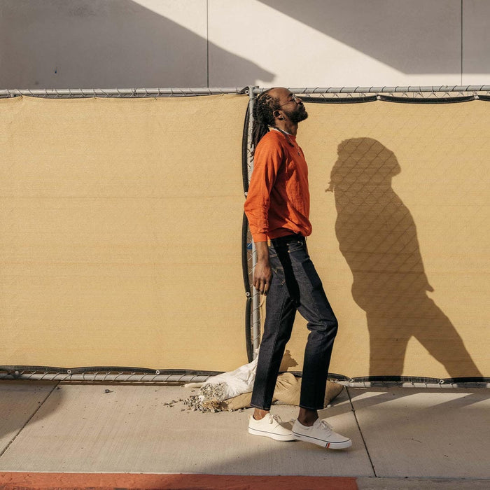 SeaVees Coastal Cruiser sneakers in white canvas with minimalist design, worn outdoors by a walking person.