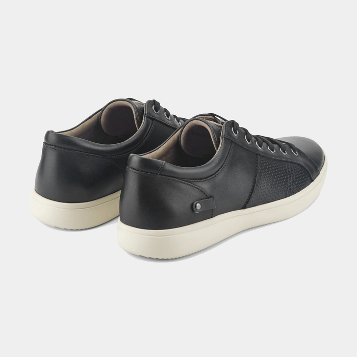 Rockport Colle Tie casual sneakers in black leather with textured side panels and white rubber outsole, back angle view.