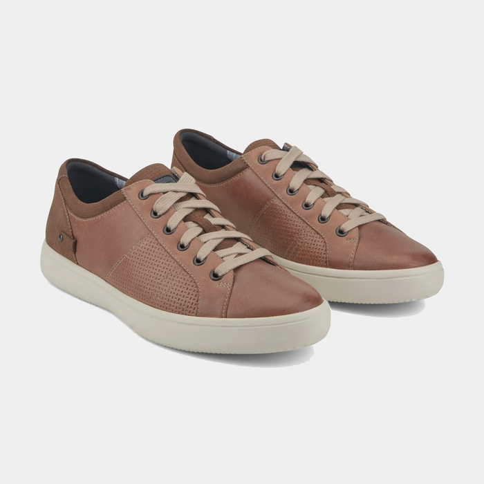 Rockport Colle Tie casual shoes in brown leather with perforated detailing, beige laces, and white rubber outsole, angled front view.